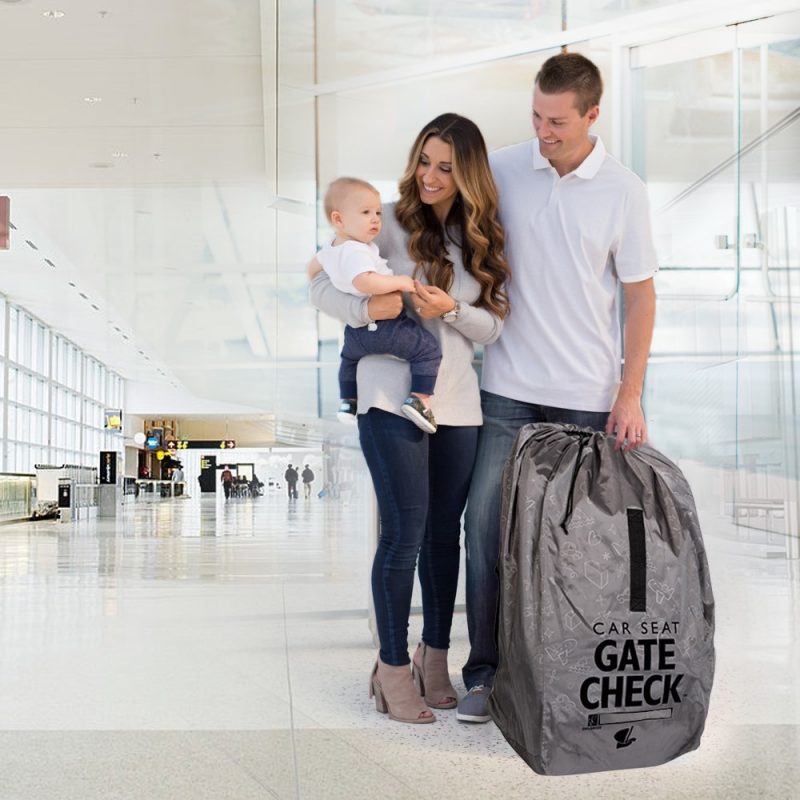 Family standing next to the Deluxe Gate Check Travel Bag for Car Seats