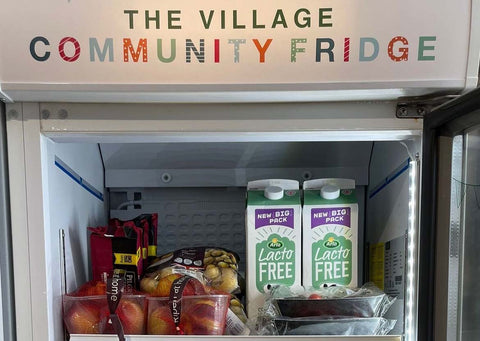 Community fridge containing fruit and milk