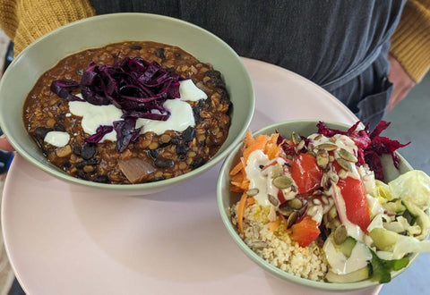 Black bean stew and salad combo displayed in bowls