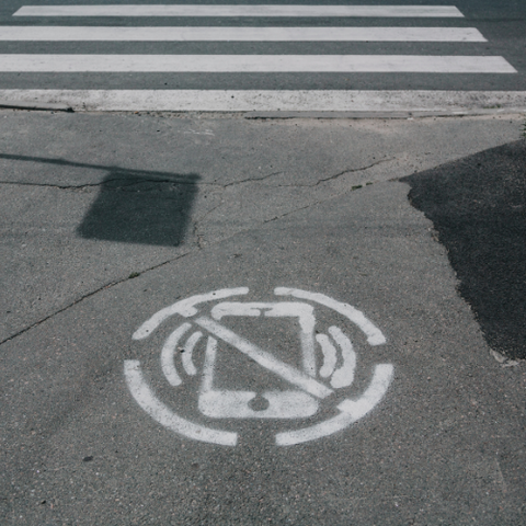 A no-phones chalk drawing on pavement