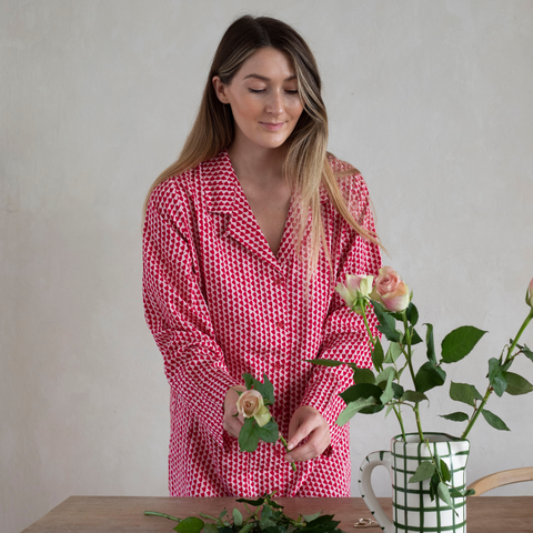 arranging flowers in a red hounds of love nightshirt