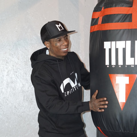 Pro boxer Maybach Hot in our "Repetition" Hooded sweatshirt inside boxing gym. "train to kill" May