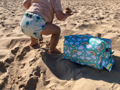 Cute Baby on the beach wearing a cloth nappy