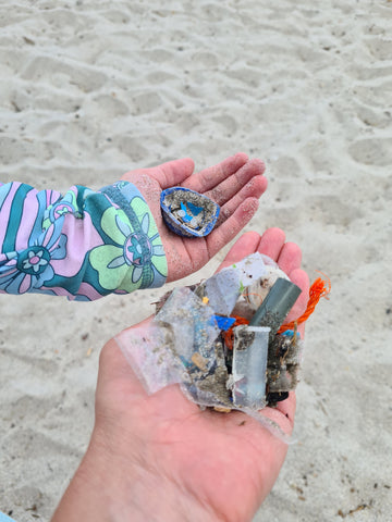 Plastic pieces found on a beach clean up. Hands holding small plastic pieces