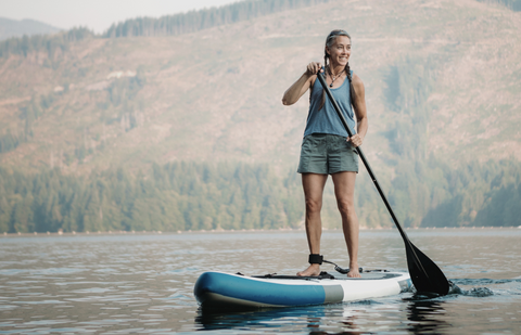 A person with inflatable stand up paddle board.