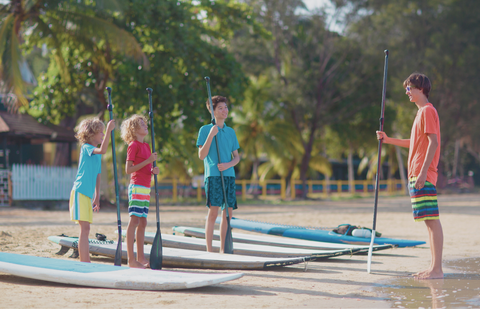 kids with paddle boards ready for water adventure