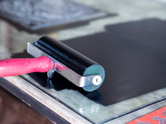 A brayer rolling out ink ready for printmaking.