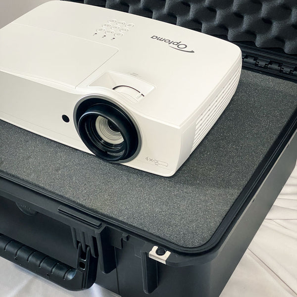 Optoma white projector from top right view and its case