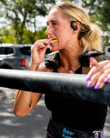 Danielle Brandon puts the AIRWAAV ENDURANCE Performance Mouthpiece (DBE Edition) into her mouth before an exercise