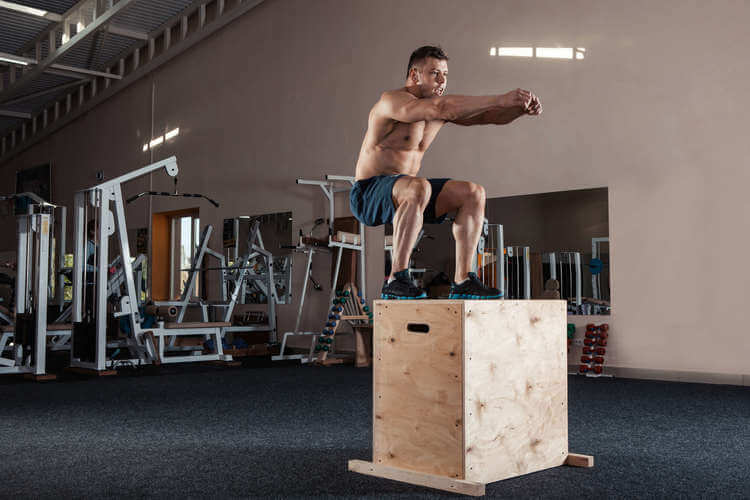 bodybuilder doing box jumps