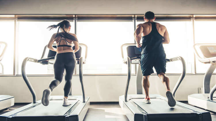 couple doing cardio exercise on treadmill