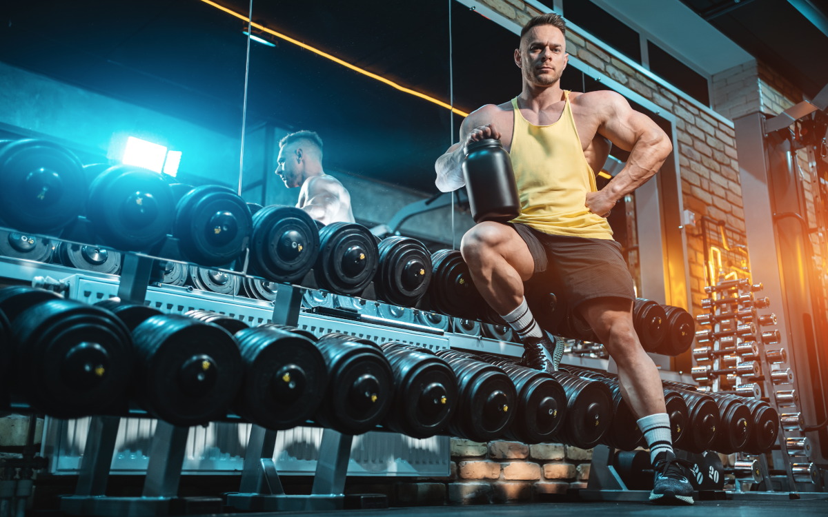 Bodybuilder holding weight gainer