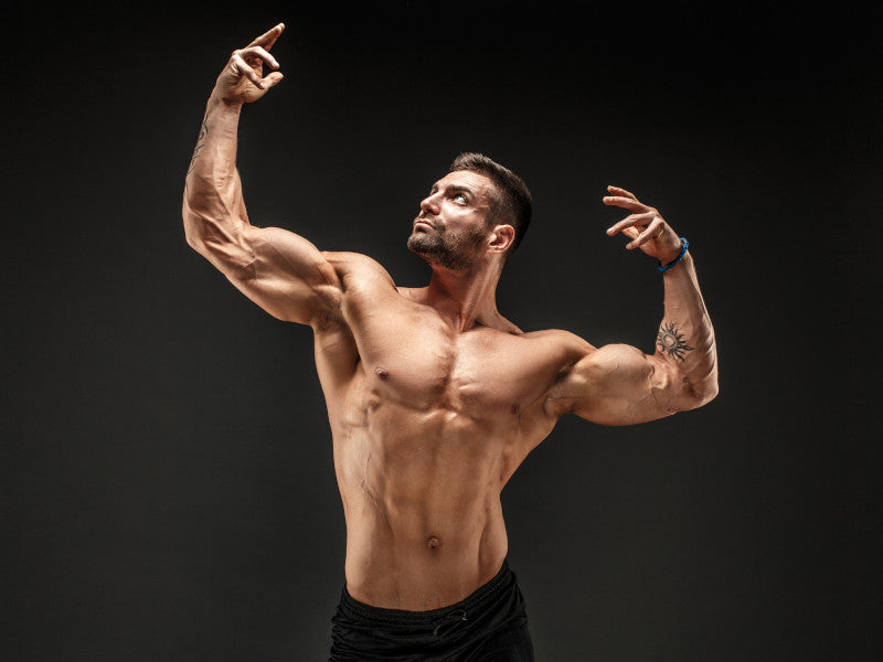 Bodybuilder practicing poses for competition