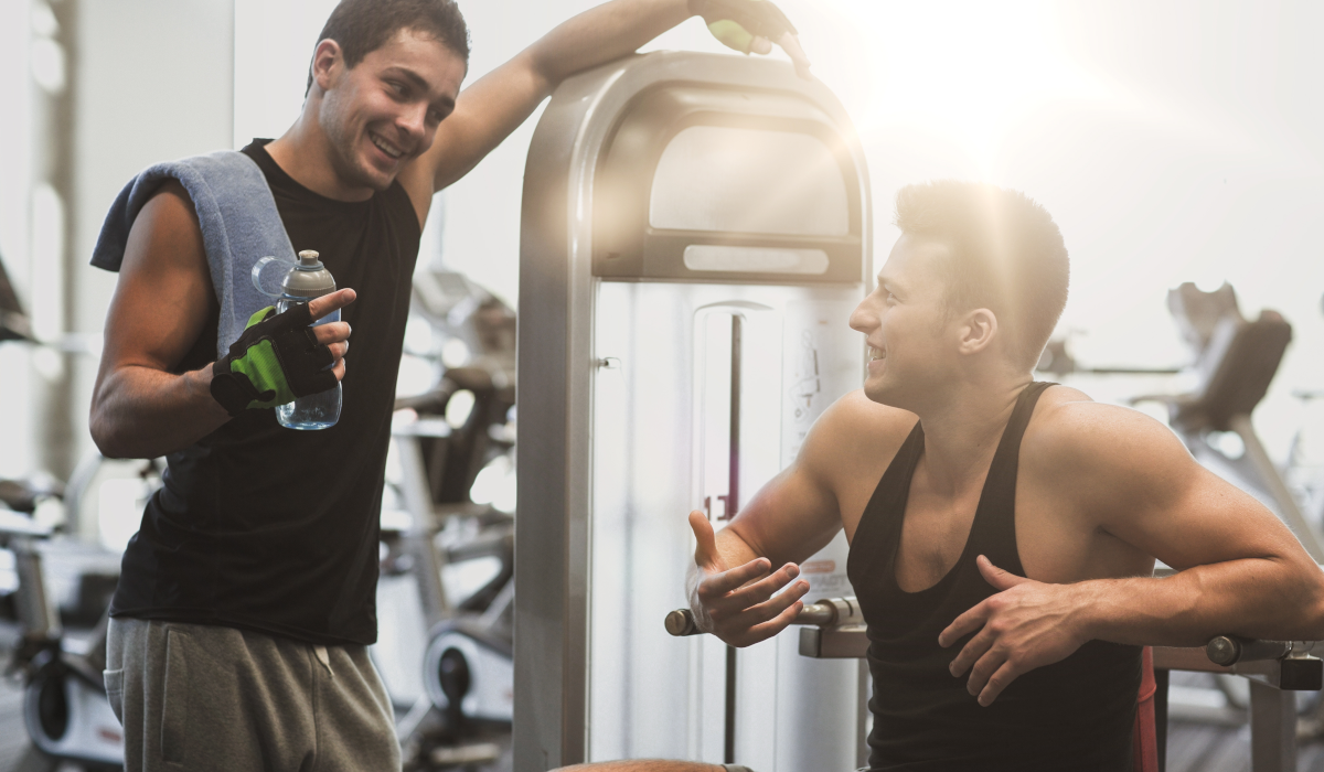 two men talking in the gym