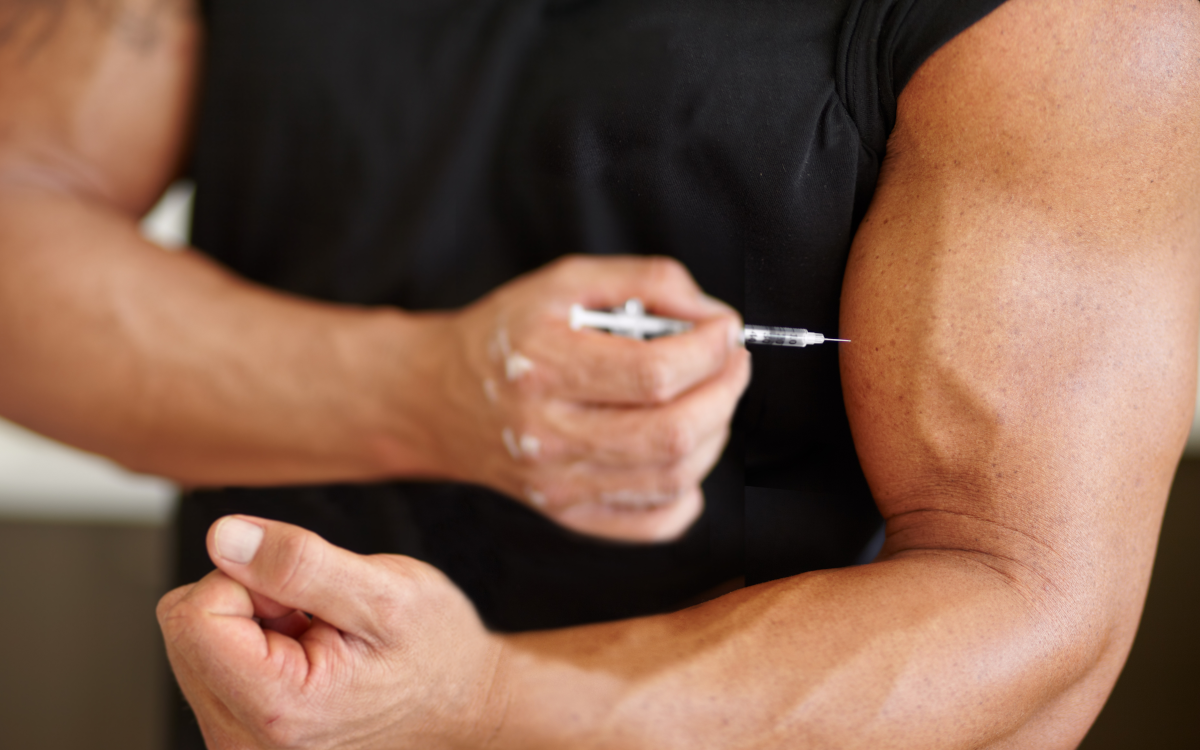 man injecting steroids