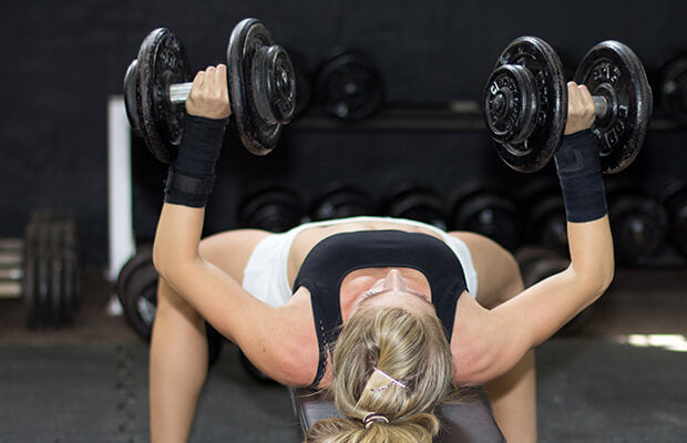 woman doing incline dumbbell press