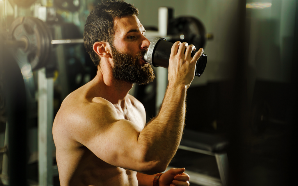 Man drinking bodybuilding supplement