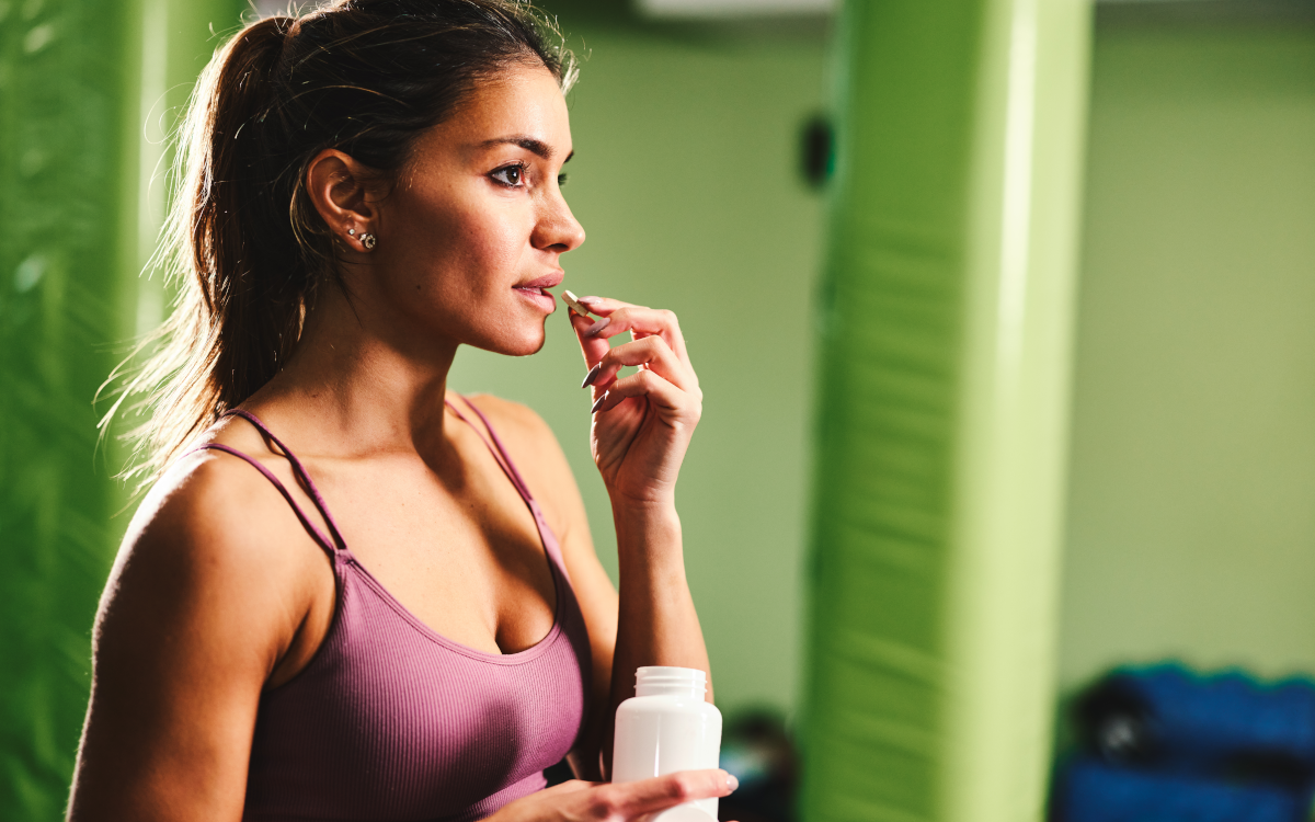 Woman takes post-workout supplement