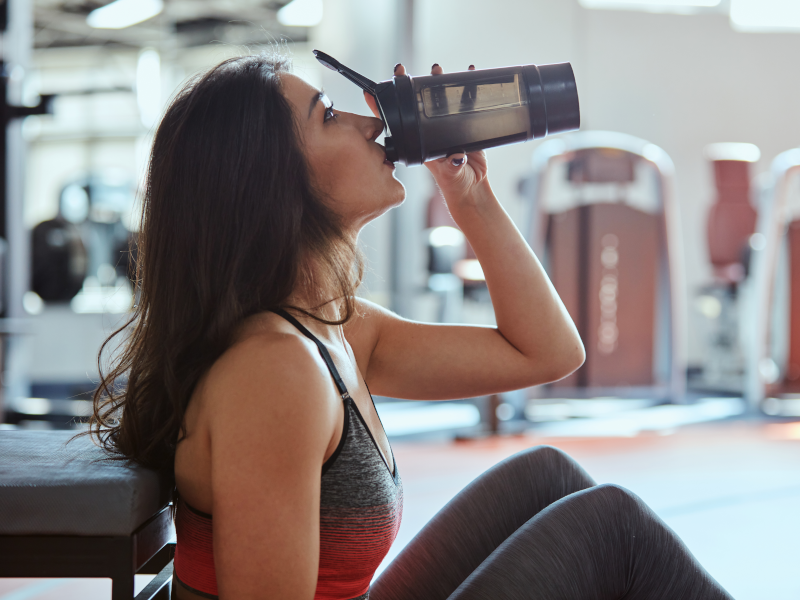 Woman drinks pre workout supplement