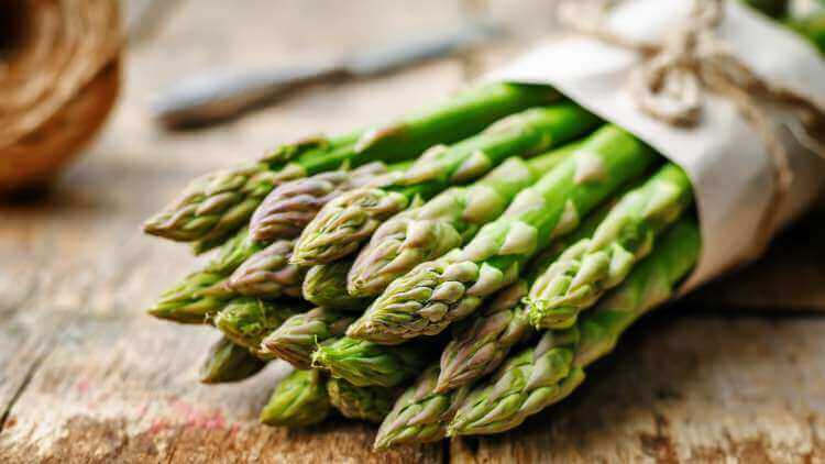 Asparagus bunch on wooden table