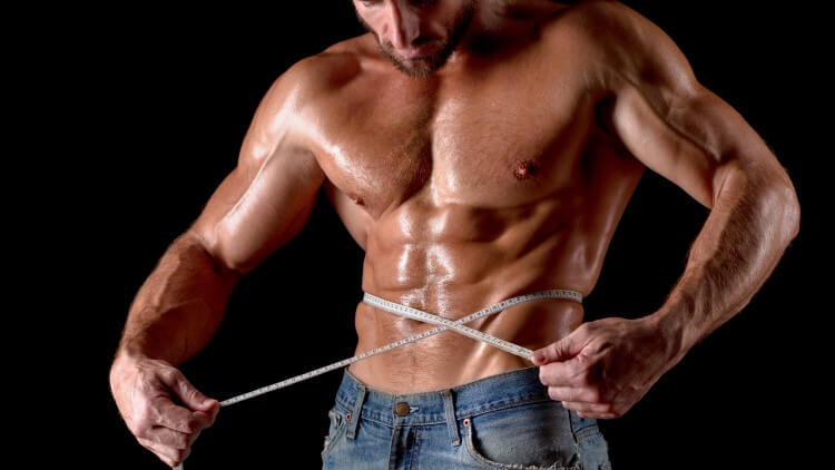 Bodybuilder with tape measure around chest