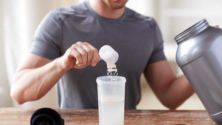 man makes protein shake