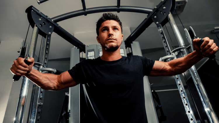 Man using cable machine in gym