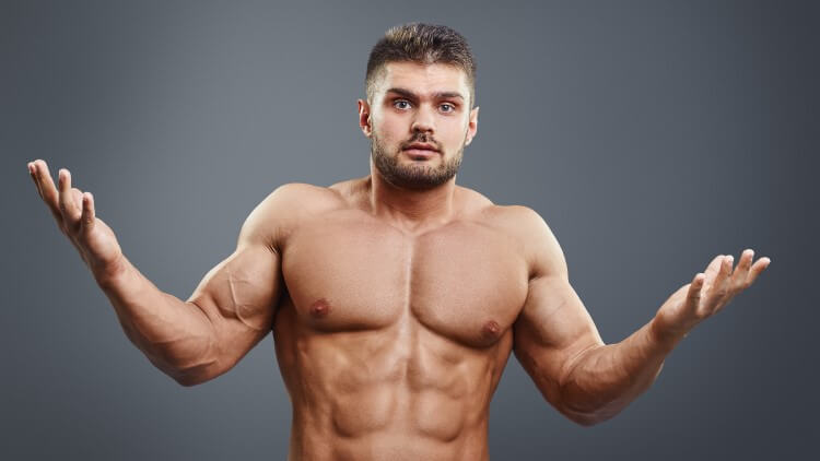 Muscular shirtless young man looking confuse