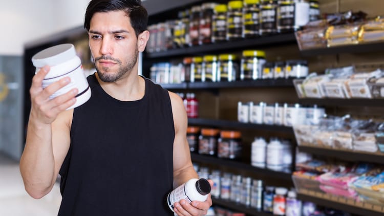 weightlifter choosing supplements