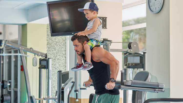 bodybuilder works out with son