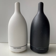 Load image into Gallery viewer, This uber stylish ultrasonic aroma diffuser or electric diffuser is available from www.thankyoufor.co.uk and comes in either black or white. Includes presentation gift box. Image shows both product examples and colours. 
