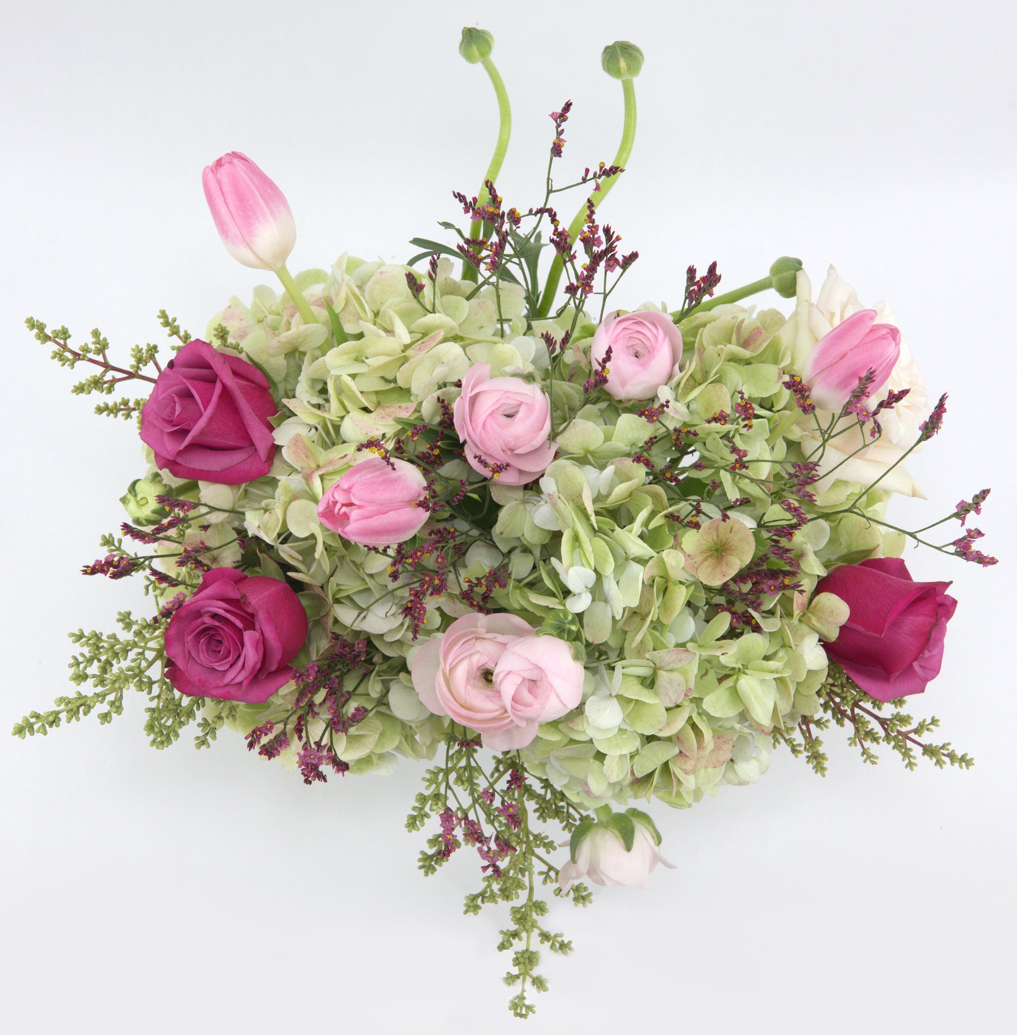 Blooms of Hope by Flower Co. is a floral design in shades of green, pink and fuchsia featuring premium flowers such as hydrangeas, roses, ranunculus, tulips, limonium and foliage. Made by local florists with same-day deliveries in Toronto and Southern Ontario.