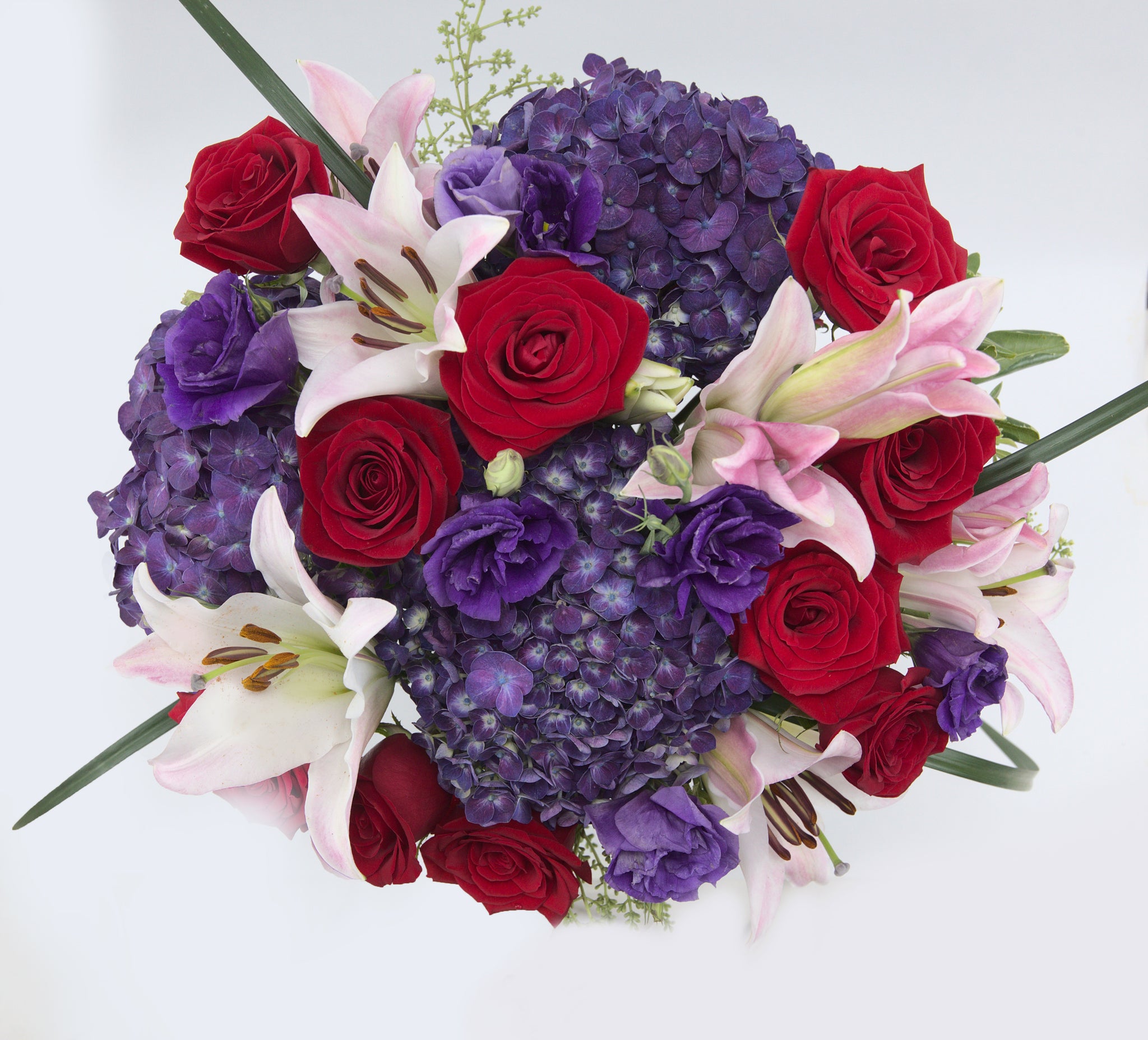 Love Shine Luxury Bouquet Top - vase of purple hydrangea, purple double lisianthus, red roses, pink roses, pink Asiatic Lilies, and lush greens
