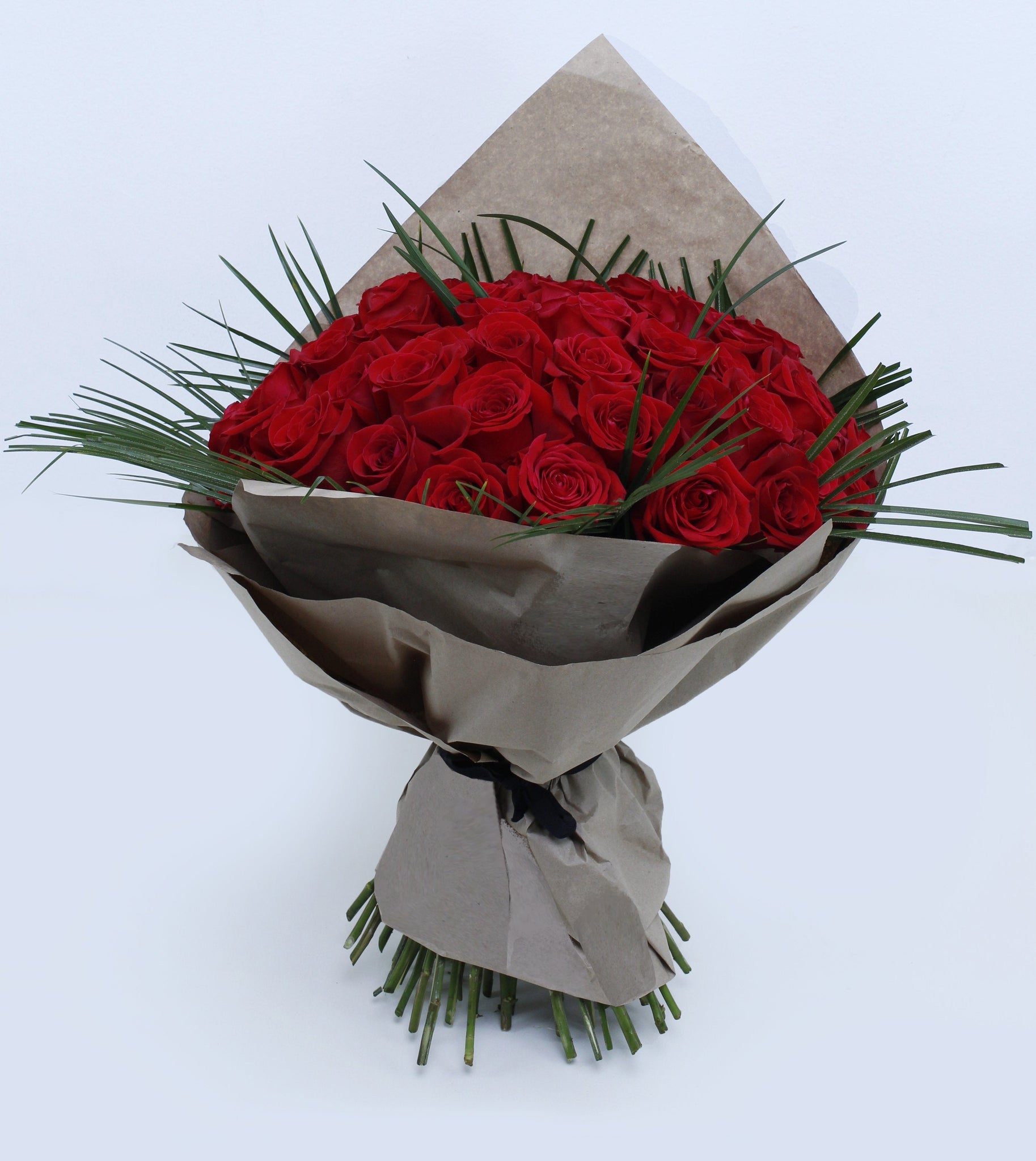 Unforgettable 50 Rose Hand-tied - red roses , palm leaves , steel grass, bouquet