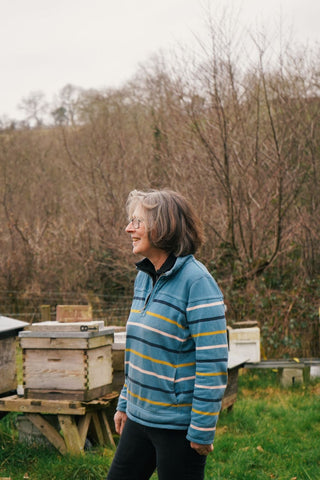 A lady standing by her beehives