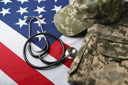 Image of the American flag with fatigues and a stethoscope on top