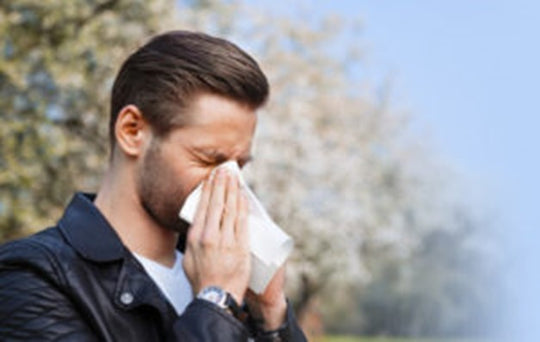 Image of a man blowing his nose