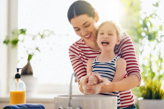 Image of a mother and daughter washing hands together