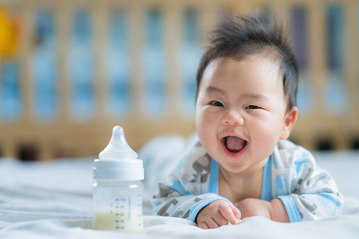 Image of adorable baby with bottle