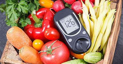 Image of a diabetic testing meter amid healthy vegetables