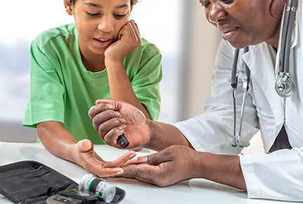 Image of doctor administering a diabetes stick test to a young patient