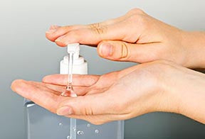 Image of person using hand sanitizer