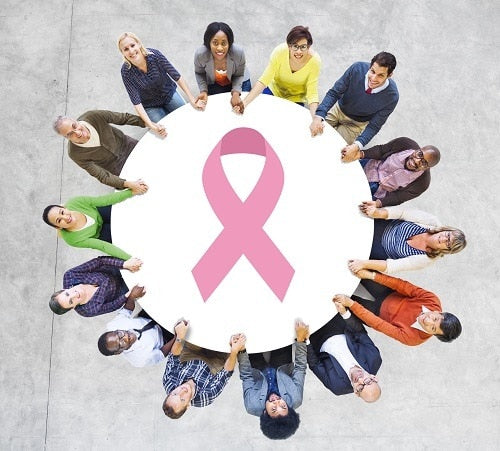 Image of people holding a safety net with the pink ribbon emblem on it
