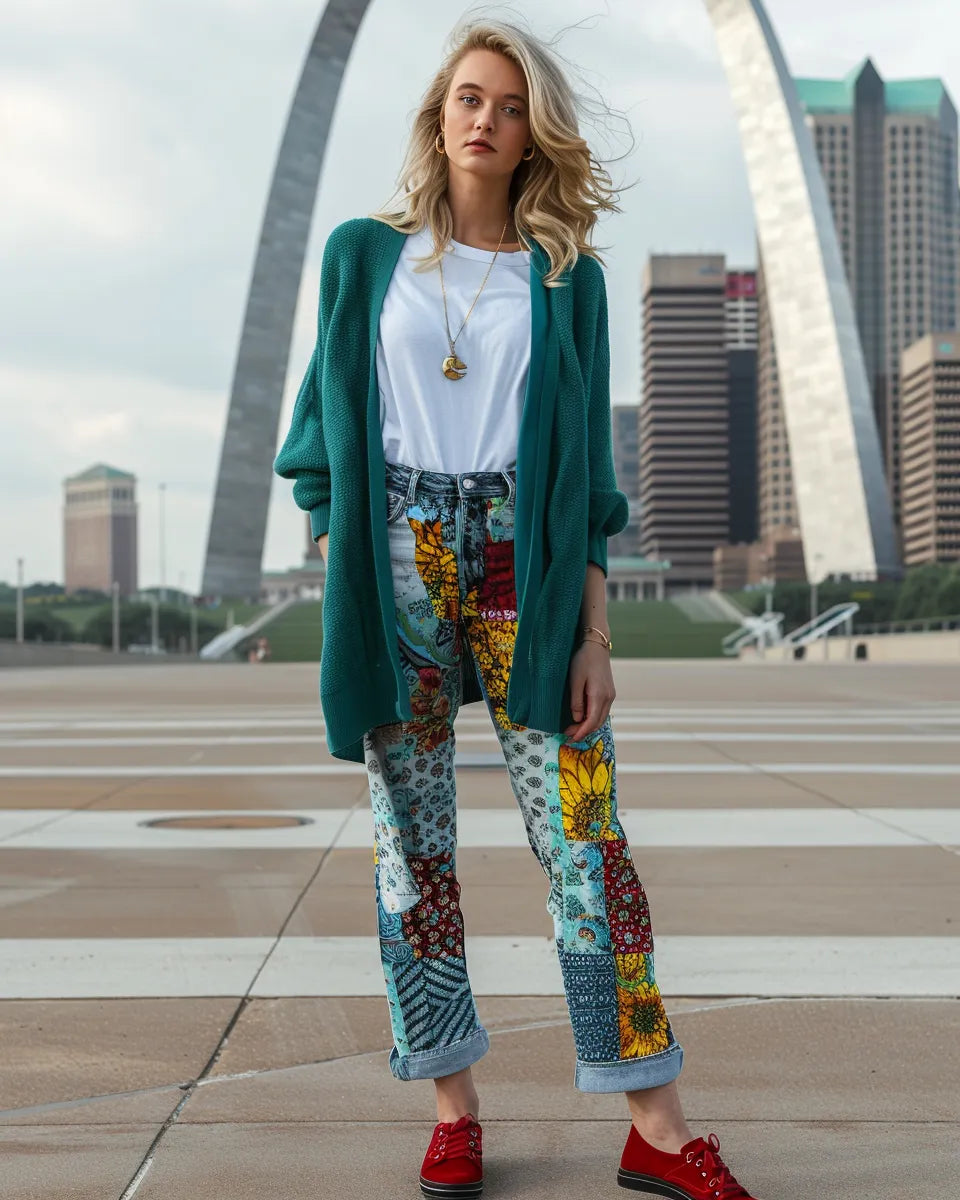 Woman in vibrant patchwork jeans, white tee, red sneakers, lavender blouse, black heels, gold jewelry, teal cardigan. Summer season. White female. Gateway Arch, St. Louis, MO city background.