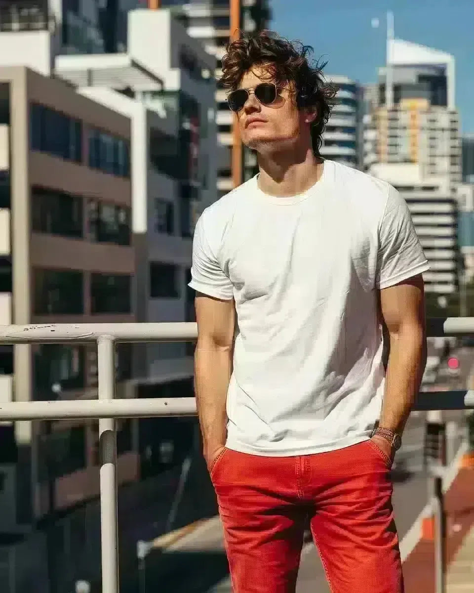 Australian male model in slim-fit red jeans, urban Queensland backdrop. Spring season.