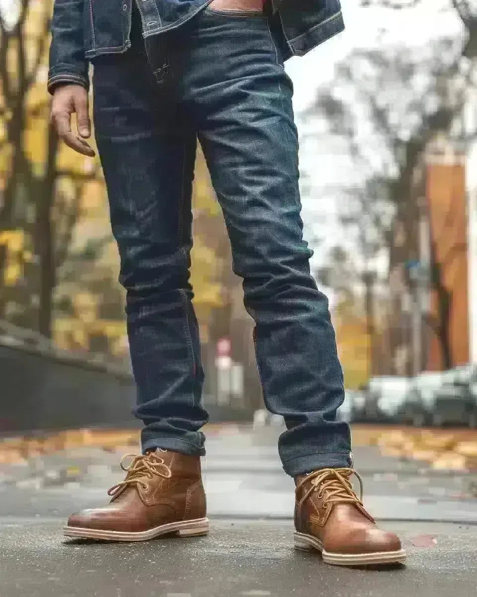 Diverse man in modern office fashion selvedge jeans with raw hem and faded indigo, outdoor. Spring season.