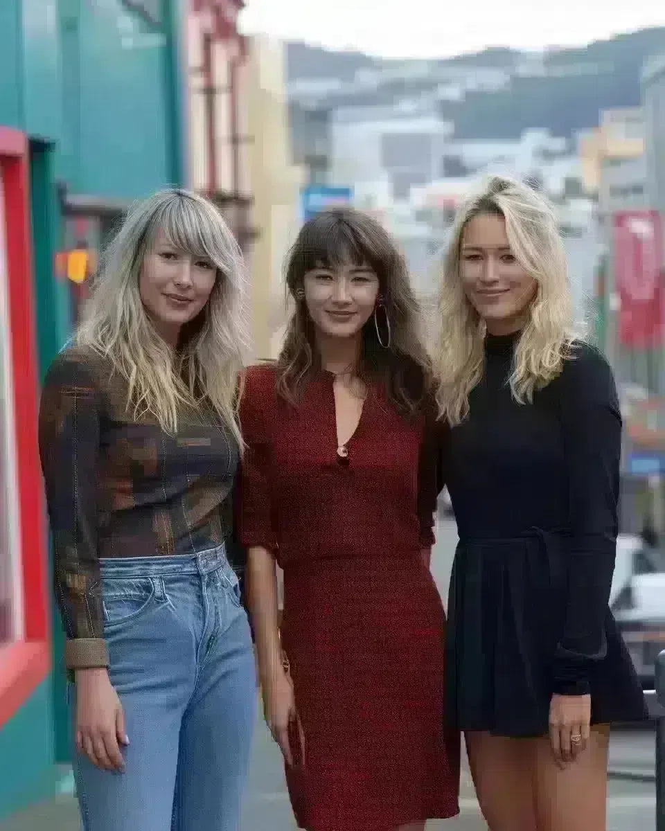 Diverse women in jeans dresses, downtown Wellington backdrop. Late Winter  season.