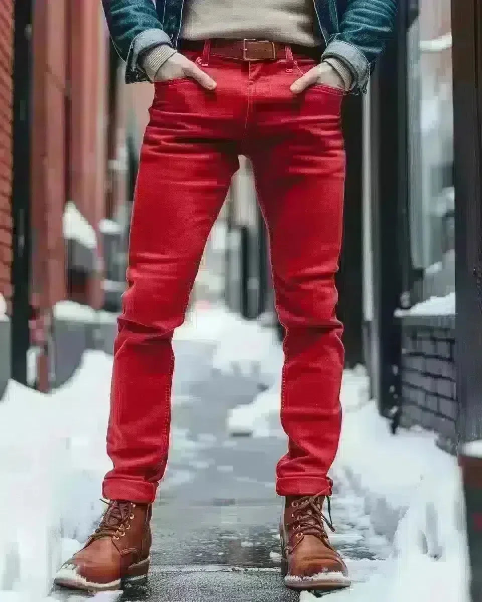 Man in vibrant red jeans, denim texture, outdoor urban setting. Winter  season.