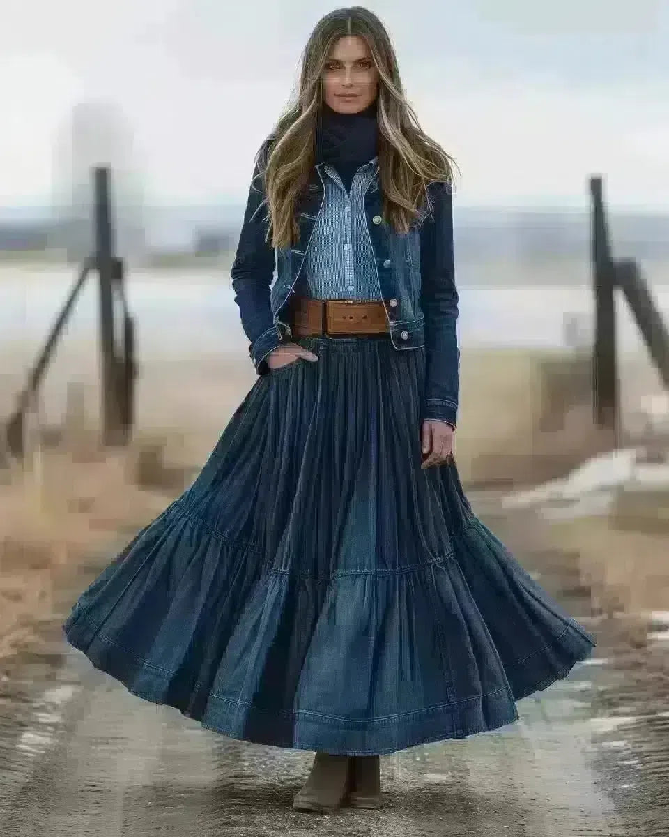 Woman in long denim skirt, twilight blue, A-line silhouette, outdoor setting. Winter  season.