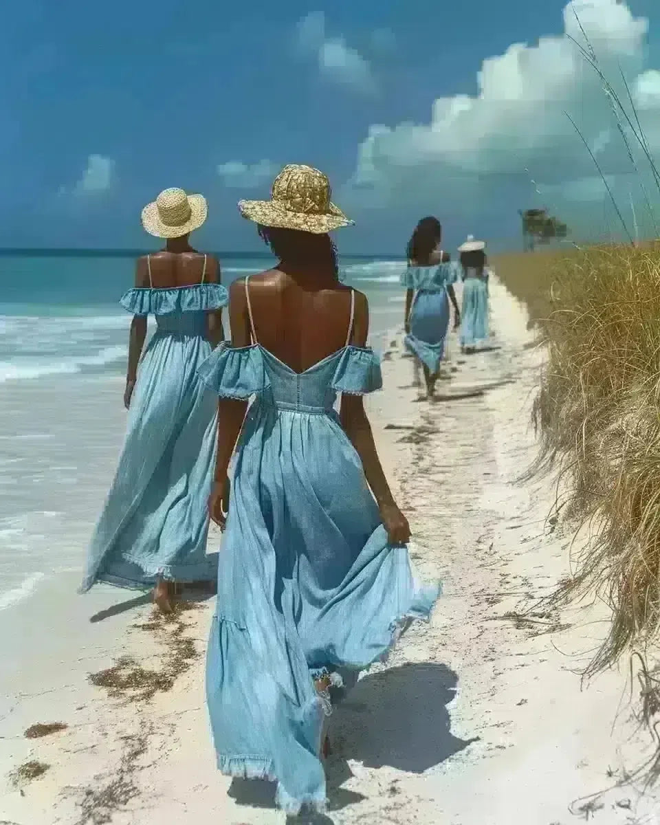 Ethnic women in long denim dresses at a Florida beach. Late Winter  season.